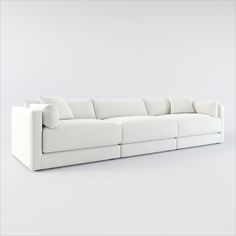 a white couch with pillows on top of it