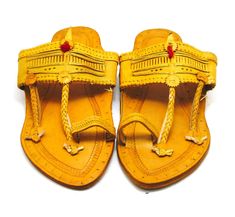 Check out our brand-new, genuine handcrafted Kolhapuri sliding sandals from India, high-quality leather sandals with an ethnic Indian toe strap that are incredibly comfortable and simple to use. The leather is prepared in such a way that it has no allergenic characteristics at all and feels light, smooth, and silky. Hand stitching and punching are being used. These unisex slippers are ideal for everyday use as well as for any formal event. We offer various different shoe styles. For more of our selection, visit our page! We send packages to you promptly and well packaged for a safe journey. We appreciate your support of our little business. Shipped from the USA. Traditional Brown Toe Post Flip Flops, Yellow Open Toe Slippers, Traditional Leather T-strap Sandals With Closed Toe, Traditional Closed Toe Leather T-strap Sandals, Traditional Toe Ring Slip-on Sandals For Beach, Traditional Slip-on Toe Ring Sandals For Beach, Traditional Leather T-strap Closed Toe Sandals, Traditional Adjustable Brown Flip Flops, Traditional Festival Sandals With Leather Sole