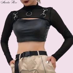 This Trendy Blouse Is All About Making A Bold Statement With Its Snug Fit And Chic Black Shade. The High Collar And Shiny Finish Give It A Sophisticated Yet Cool Vibe, Perfect For Nights Out Or Stylish City Days. It Features Stylish Cut-Outs On The Shoulders And Back, Adding A Funky Twist While Keeping You Cool On The Go. It's An Awesome Pick For Those Who Want To Look Sharp Without Sacrificing Comfort. Decked Out With Silver Rings And Links At The Collar And Shoulders, This Top Mixes A Bit Of I Gothic Mesh Top For Spring Party, Spring Gothic Party Mesh Top, Spring Party Gothic Mesh Top, Fall Club Tops With Stretch, Stretch Tops For Club Nights In Fall, Stretch Tops For Club In Fall, Spring Gothic Mesh Top, Stretch Top For Club In Fall, Punk Style Stretch Cropped Tops