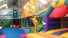 an indoor play area with slides and bounce houses