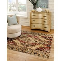 a living room area with a chair, dresser and rug