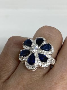 Unusual Deep Toned Sapphire Sterling Filigree Setting Handmade Size 6.25 Can be resized My jeweler charges $10-$20 All rings are shipped in a nice gift box. Check out our over a THOUSAND great reviews Engraving is $4 per letter and is not always perfect depending on the piece. It can take a few days if the jeweler is busy. This is payable to Paypal Judithsltd@gmail.com Blue Gemstone Flower Ring Gift, Gift Blue Gemstone Flower Ring, Blue Flower Ring For Anniversary, Blue Gemstone Flower Ring, Elegant Blue Flower Ring As Gift, Blue Flower Rings For Formal Occasions, Blue Pear-shaped Sapphire Ring Gift, Blue Flower Shaped Gemstone Ring, Blue Flower-shaped Gemstone Ring