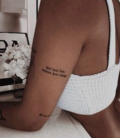 a woman with a tattoo on her left arm and the words food, love, laughter written in cursive font