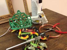 some scissors and other crafting supplies on a table with a mirror in the background