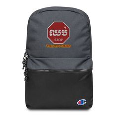 a grey backpack with a red stop sign on the front and yellow lettering across the bottom