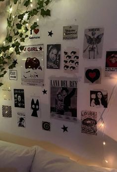 the wall is covered in posters and lights, with ivy growing up to it's right side