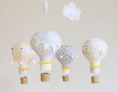 three hot air balloons hanging from the ceiling in a nursery or kids's room