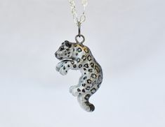 IMPORTANT: Due to a surge in holiday orders I currently have a 2-3 week waiting period for all orders before I can ship them. Please take this into account before ordering as unfortunately I am not able to ensure delivery of an item before 2-3 weeks. I am very sorry for any trouble. ----------------------------- A perfect gift for yourself or the snow leopard lover in your life! This dashing one sided snow leopard was cast in resin, hand painted with acrylic paints and metallic rub, then finishe Snow Leopard Jewelry, Fox Cake Toppers, Leopard Accessories, Leopard Necklace, Very Sorry, Black Wolf, Colored Gems, Snow Leopard, Animal Jewelry