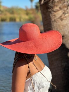 Gorgeous burn salmon color sun hat in an 8" wide brim. Hand woven in a brisa weave with a round dome crown. Available in medium and large. Our hats are handwoven with extreme attention to detail and dedication to traditional techniques. Each Paja Toquilla hat is a testament to the slow fashion movement, honoring the skill and artistry of our artisans who have faithfully preserved their craft for generations.  OUR HAND CRAFTED HATS PROCESS Paja toquilla, is a palm-like plant which is used to weave our hats and can be found off the coast of ecuador.  the soft middle palm leaves are washed and placed out in the sun to dry. the sun bleaches the straw, making it strong and flexible for easy weaving.  weaving is a unique skill, depending on the fineness of the weave, a single hat can take up to Wide Brim Pool Hat, Straw Hat For Travel To Kentucky Derby, Adjustable Orange Sun Hat For Vacation, Orange Summer Sun Hat For Vacation, Elegant Wide Brim Sun Hat With Uv Protection, Orange Brimmed Straw Hat For Beach, Orange Brimmed Sun Hat For Vacation, Adjustable Orange Straw Hat For Summer, Orange Brimmed Sun Hat For Summer