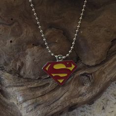 a necklace with a superman symbol on it