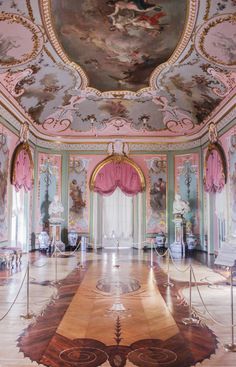 an ornately decorated room with paintings on the walls and ceiling, in pastel colors