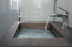 a bathroom sink with water running from the faucet