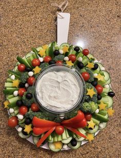 a plate with vegetables and dip on it