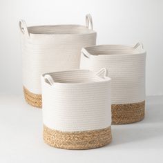 three white baskets with jute handles on them