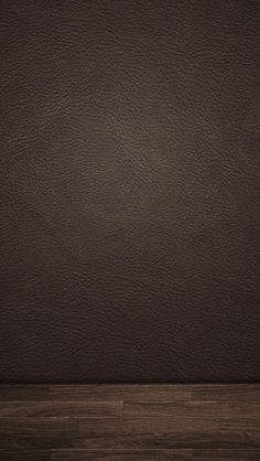 a brown leather textured wall with wood flooring in the foreground and an empty space for text