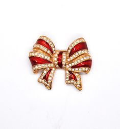 Large Red stripe bow with clear stones and gold tone backing Very beautiful! Elegant Christmas Party Brooches, Elegant Christmas Brooches For Formal Occasions, Gold Brooches For Formal Christmas Occasion, Gold Christmas Brooches For Formal Wear, Elegant Holiday Jewelry Brooch, Elegant Gold Brooches For Christmas, Gold Bow Brooch For Party, Formal Red Rhinestones Brooches, Red Rhinestone Brooch For Gift