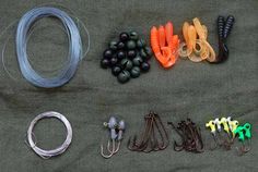 several different types of fishing equipment laid out on a table with string, hooks, and other items