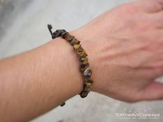 "Tiger Eye bracelet, a braided brown cuff or stacking wristband with protection stones. A perfect gift for him or her, or for that special one that loves yoga and natural stones. The bracelet is braided on 2mm brown satin cord with adjustable knot finish. Due to the adjustable sliding knot finish, it can fit perfect to everyone. Check below the dimensions and cord length. If you want bigger size bracelet please contact me. The listing is for one bracelet similar to the bracelet shown in photos w Adjustable Braided Bangle Jewelry, Natural Stones Leather Bracelet Gift, Adjustable Hand-strung Leather Bracelet, Adjustable Leather Spiritual Bracelet As Gift, Adjustable Spiritual Leather Bracelet Gift, Casual Adjustable Braided Bracelets With Natural Stones, Casual Braided Bracelets With Natural Stones, Hand Wrapped Brown Braided Bracelets For Gift, Hand Wrapped Brown Braided Bracelet Gift