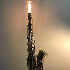 a saxophone is lit up by a light bulb