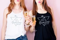 two beautiful young women standing next to each other holding wine glasses in their hands and making funny faces