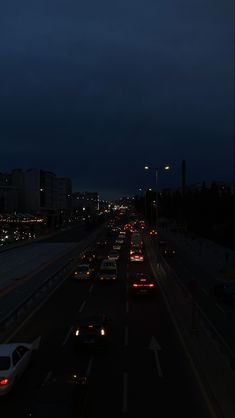 cars are driving down the highway at night