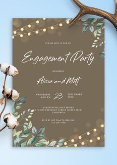 an engagement party card with cotton flowers and lights