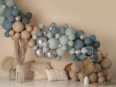 some balloons are hanging on the wall above a table with other decorations and decor items