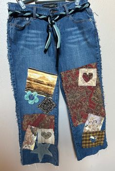 a pair of blue jeans with patchwork on them