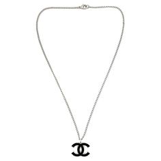 An iconic Vintage Chanel CC Logo Necklace from the 2006 Spring collection. Elevate your look with this classic from the House. Vintage Condition: Very good without damage or noteworthy wear. Signed: Chanel, 2006 Materials: rhodium plated metal, enamel Fastening: lobster clasp Approximate Dimensions: 43.5cm, pendant 2cm Established in 2016, this is a British brand that is already making a name for itself in the jewellery world both at home and internationally. My business has been built with love; a love of discovery, a passion for vintage jewellery and a desire to deliver a one-of-a-kind experience. Sourcing the very best vintage jewellery from across the globe, each piece in my collection has been carefully chosen and curated by me so that I can share its unique story with you. Timeless t Chanel Logo Necklace, Luxury Round Channel Set Necklaces, Logo Necklace, Chanel Necklace, House Vintage, Chanel Logo, Vintage Jewels, Chanel Black, Cc Logo