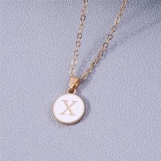 Add a personalized touch to your look with our YourLetter White Enamel Circle Necklace. Crafted with a white enamel background and gold color detailing, the necklace comes with a choice of single letter pendant. A great way to show off your initials or those of someone you love. Gold Initial Pendant Necklace With Letter Print, White Initial Pendant Necklace With Monogram, White Monogram Initial Pendant Necklace, White Monogram Initial Necklace, Dainty White Personalized Necklace, Gold Initial Necklace With Letter Print As Gift, White Minimalist Initial Pendant Necklace, Personalized Gold Enamel Charm Necklace, Dainty White Initial Necklace Gift