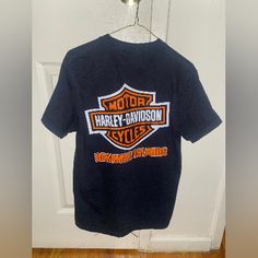 a harley davidson shirt hanging on a door