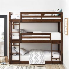 a bunk bed with two sets of ladders on the bottom and one set of stairs to the top