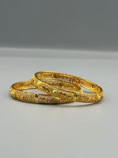 Our 24k Polished Bangles are more than just accessories; they are symbols of grace and beauty, inspired by the rich heritage of Indian, Pakistani, and Nepali jewelry. These stunning bangles showcase the timeless elegance of traditional craftsmanship, perfectly complementing your attire for weddings, festivals, or any special occasion Our company offers expedited Next-Day Delivery Services within the United Kingdom, ensuring prompt and efficient transportation of goods.  Additionally, we strive to extend our shipping capabilities to cater to customers worldwide, aiming to provide the fastest possible shipping methods to international destinations. To ensure the highest standards of hygiene, we kindly request your understanding that all sales are final, and we are unable to accept returns or Traditional Bangle With Elegant Design As Gift, Festive 22k Gold Openable Jewelry, Elegant Openable Bangle For Festivals, Elegant Gold Plated Bangle For Festivals, Intricate Gold Bracelet For Weddings, Elegant Gold-plated Openable Bracelets, Traditional Yellow Gold Bangle, Intricate Design Gold Bracelet For Wedding, Elegant Gold Plated Openable Bracelets