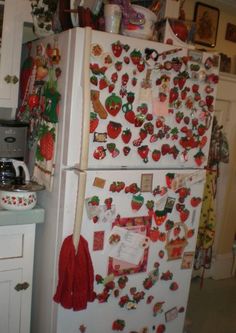 a refrigerator covered in magnets and christmas decorations