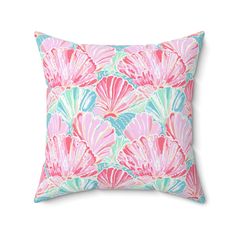 a pink and blue pillow with shell print