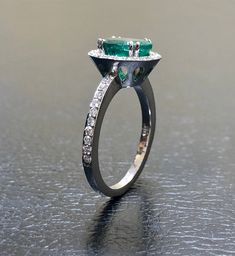 DeKara Designs Collection Our latest design! An elegant and lustrous Colombian Emerald surrounded by beautiful diamonds in a halo setting. Metal- 14K White Gold, .583. Stones- 1 Oval Colombian Emerald 1.25-1.40 Carats, 40 Round Diamonds, F-G color VS clarity, 0.30 carats. Latest of my creations. A beautiful Oval Colombian Emerald Halo Diamond Ring. The Emerald is a beautiful green and it is professionally prong set in between four double prongs. There are ten pave set round diamonds on each side Luxury Marquise Emerald Ring With Diamonds, Luxury Oval Emerald Cluster Ring, Dazzling Oval Emerald Ring In Platinum, Luxury Platinum Emerald Ring With Halo Setting, Exquisite Oval Emerald Ring In Platinum, Oval Emerald Ring With Prong Setting In Platinum, Oval Emerald Ring In White Gold With Diamond, Oval Platinum Emerald Ring With Prong Setting, Luxury Oval Emerald Ring With Brilliant Cut