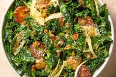 a white bowl filled with lots of green vegetables