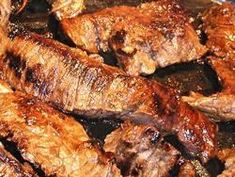 steaks are cooking in a pan on the stove