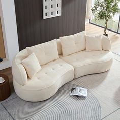 a large white sectional couch sitting on top of a rug