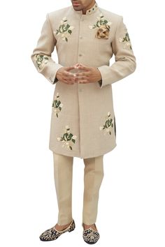 Beige tinted grey sherwani with placement floral motif work.
Components: 1
Neckline: Mandarin collar
Sleeve Length: Full sleeves
Fabric: Cotton
Color: Beige,Grey
Sequin and thread embroidery
Closure: Front buttons
Note: The pants worn by the model are not for sale. - Aza Fashions Designer Fitted Bandhgala With Floral Embroidery, Fitted Unstitched Suit With Floral Embroidery For Reception, Fitted Sherwani With Floral Embroidery For Designer Wear, Formal Nehru Jacket With Floral Embroidery And Straight Cut, Fitted Bandhgala With Floral Embroidery In Traditional Drape, Formal Nehru Jacket With Floral Embroidery And Straight Fit, Reception Sherwani With Floral Embroidery, Formal Straight Nehru Jacket With Floral Embroidery, Festive Fitted Sherwani With Floral Embroidery