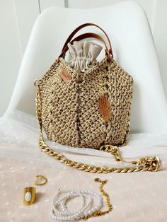 A handbag with a beautiful openwork weave, a small tulip-shaped handbag. A woven drawstring bag in the following dimensions: 33 cm width, 30 cm height. The bag has two short handles, one long adjustable strap, and a chain. The strap and chain can be used interchangeably, both are detachable. The bag is fastened with a metal magnetic button. Metal chain 120 cm long - you can shorten it very quickly by unfastening a few eyelets. You can also attach this shorter part to the bag as another decoratio Crochet Macrame Bag, Crochet Macrame, Macrame Bag, Metal Accessories, Bag Crochet, Messenger Bags, Metal Chain, Drawstring Bag, Tulips