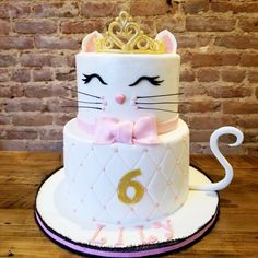 a birthday cake with a cat wearing a tiara