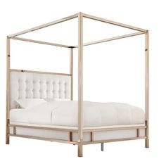 a white bed with a metal frame and headboard