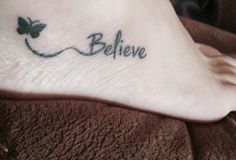 a person with a tattoo on their foot that says,'believe'and an image of a butterfly