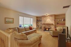 a living room filled with furniture and a fire place