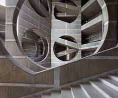 a spiral staircase in a building with concrete walls