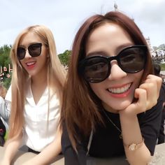 two beautiful young women sitting next to each other