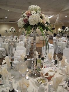 the tables are set up with white linens and silver tablecloths for an elegant wedding reception