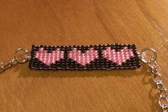 a beaded key chain with pink hearts on it