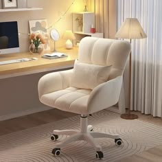 a white office chair sitting in front of a computer desk